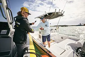 sea tow captain delivering tool to sea tow member